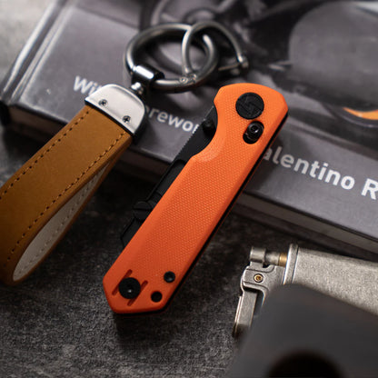 Olitans Adélie Penguins G076 - 2.68" Black Utility Blade, Orange G10 Handle