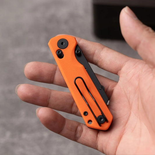 Olitans Adélie Penguins G076 - 2.68" Black Utility Blade, Orange G10 Handle