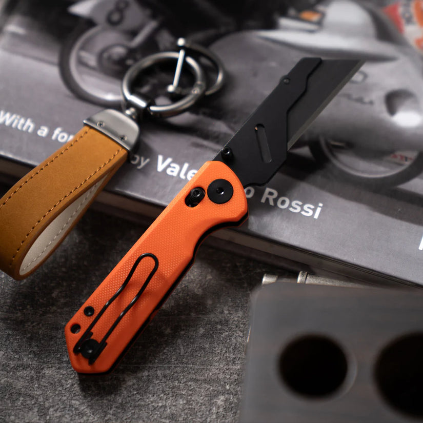 Olitans Adélie Penguins G076 - 2.68" Black Utility Blade, Orange G10 Handle