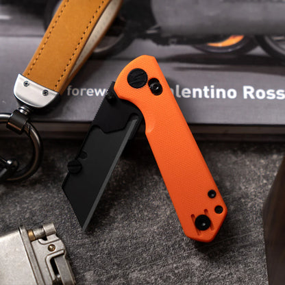 Olitans Adélie Penguins G076 - 2.68" Black Utility Blade, Orange G10 Handle