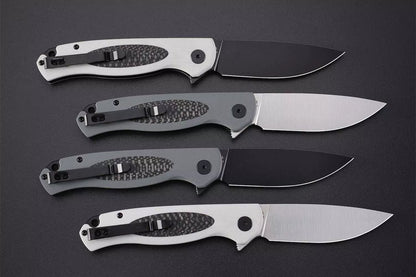 Petrified Fish Stamp PFB03 - 3.58" D2 Black Stonewashed Blade, Black G10 With Carbon Fibre Handle, Flipper